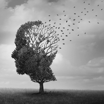 A tree in the shape of a human head stands in a grassy field; its leaves are blowing away, symbolizing memory loss or fading thoughts. The image is in grayscale, with a cloudy sky in the background.