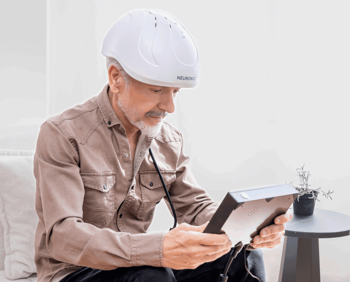 Man wearing red light therapy helmet